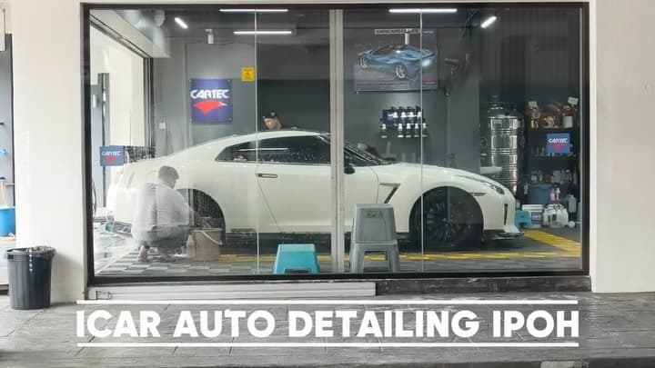 A white Nissan GT-R inside ICAR Ipoh beside the Cartec products display
