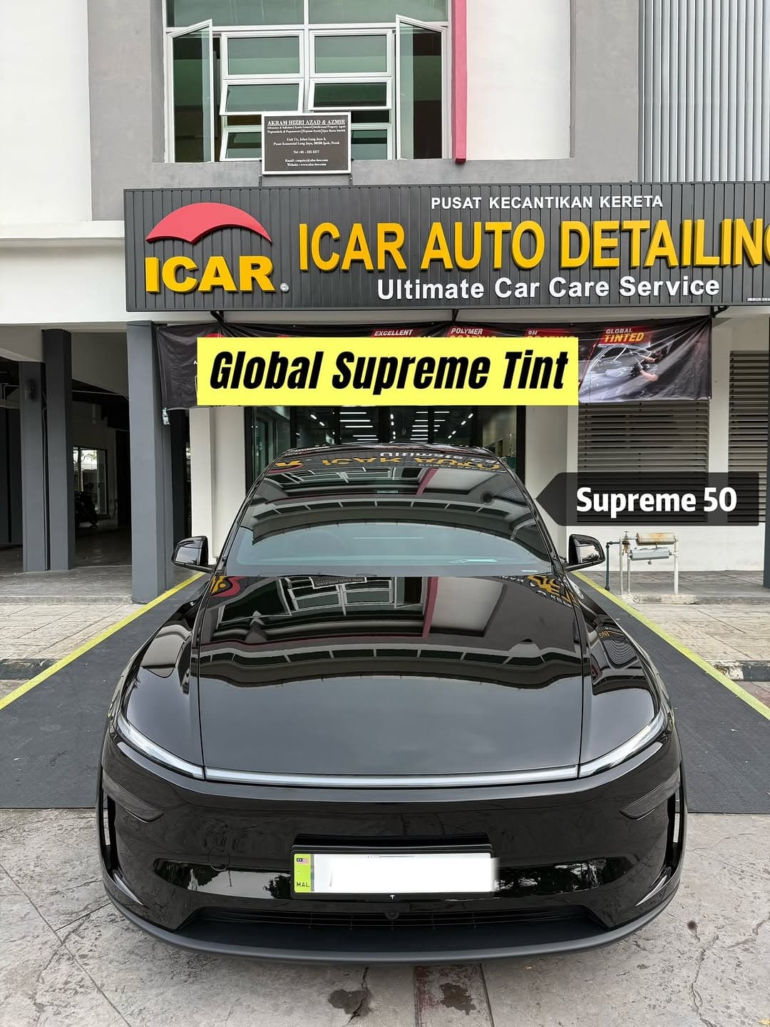 A Tesla Model Y L outside ICAR Ipoh under the Global Supreme Tint banner